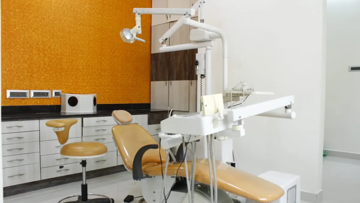 Child-friendly treatment room with a yellow dental chair at Dr. Kohila's Dental Centre